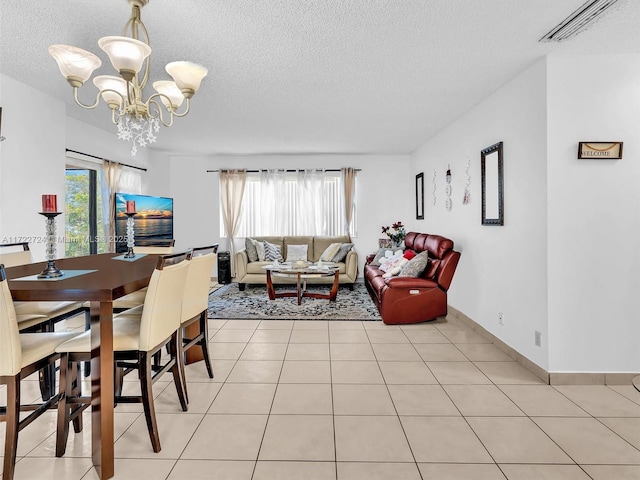 dining room featuring a notable chandelier, light tile patterned floors, a textured ceiling, and a wealth of natural light