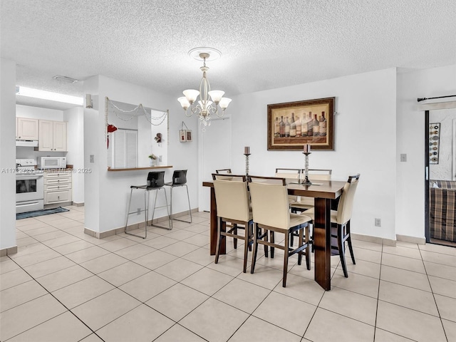 tiled dining room with a chandelier and a textured ceiling