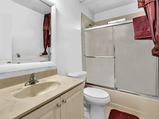 full bathroom featuring shower / bath combination with glass door, vanity, and toilet