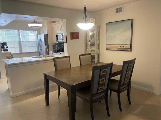 dining room with sink and light tile patterned floors