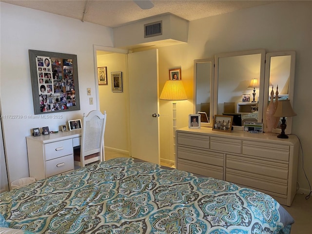 bedroom with a textured ceiling and ceiling fan