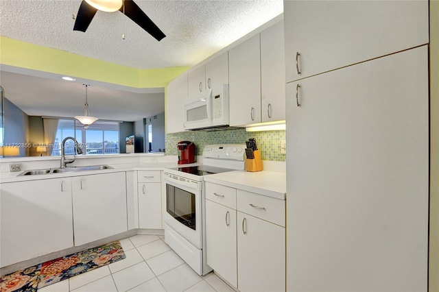 kitchen with sink, white cabinets, and white appliances