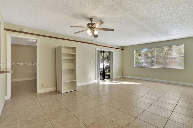 tiled spare room featuring ceiling fan and a textured ceiling