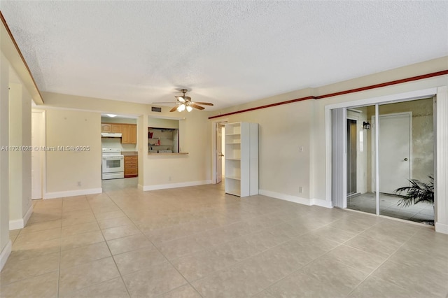 unfurnished living room featuring ceiling fan, light tile patterned floors, and a textured ceiling