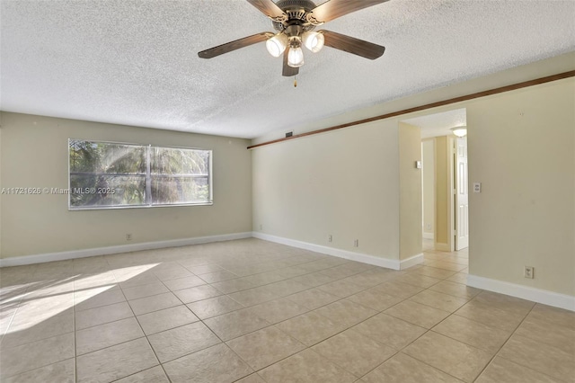 tiled empty room featuring ceiling fan and a textured ceiling