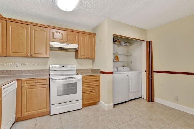 kitchen featuring light brown cabinets, a textured ceiling, white appliances, light tile patterned floors, and washer and dryer