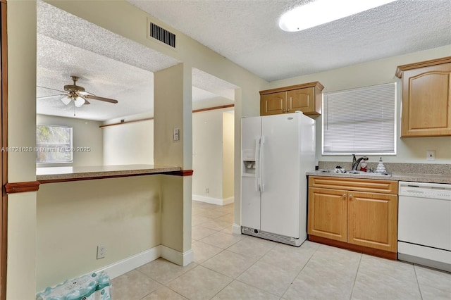 kitchen with ceiling fan, sink, a textured ceiling, white appliances, and light tile patterned floors