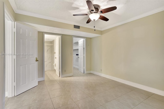 tiled spare room with ceiling fan, ornamental molding, and a textured ceiling