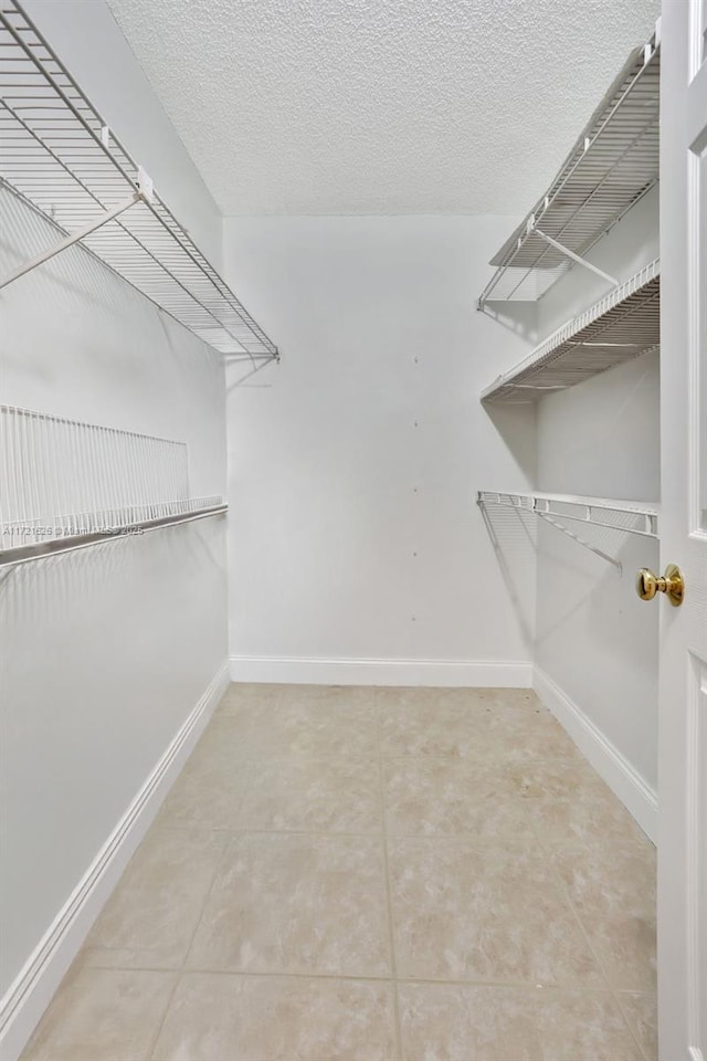 spacious closet featuring tile patterned flooring