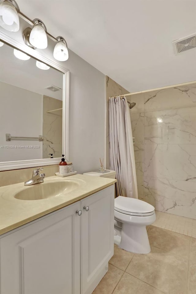 bathroom featuring tile patterned flooring, a shower with curtain, vanity, and toilet