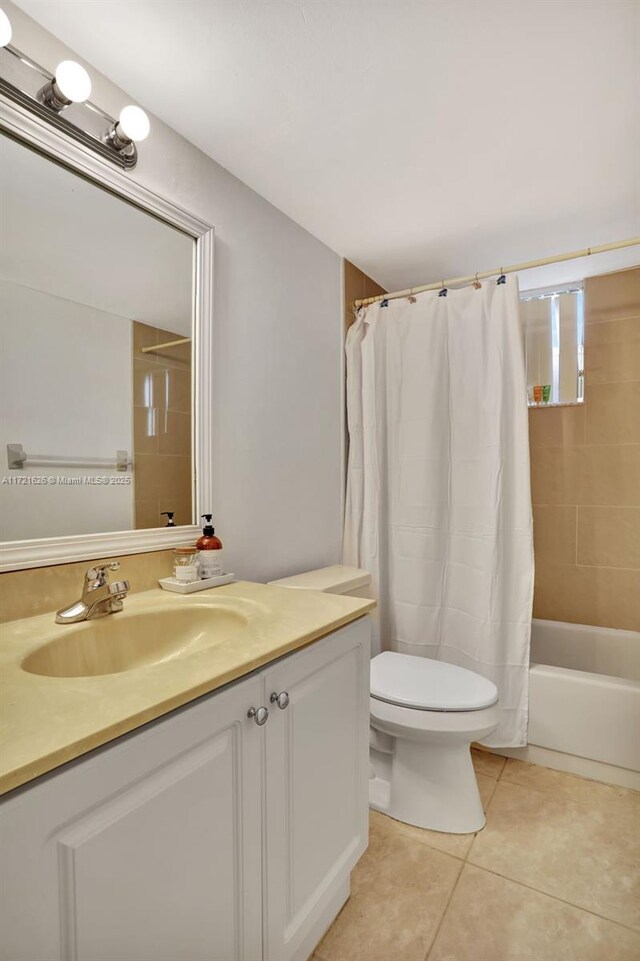 full bathroom with tile patterned flooring, vanity, shower / tub combo, and toilet