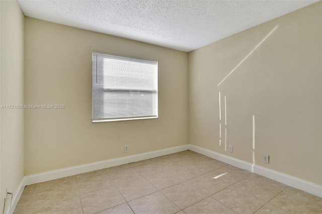 tiled spare room with a textured ceiling