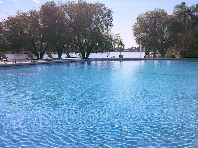 view of pool at dusk