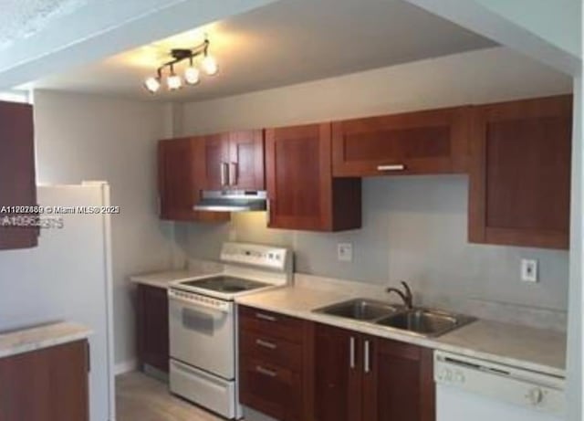 kitchen featuring white appliances and sink