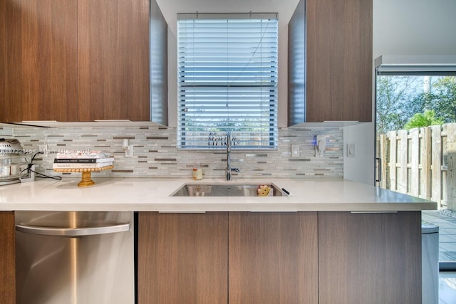 kitchen featuring dishwasher, plenty of natural light, sink, and kitchen peninsula