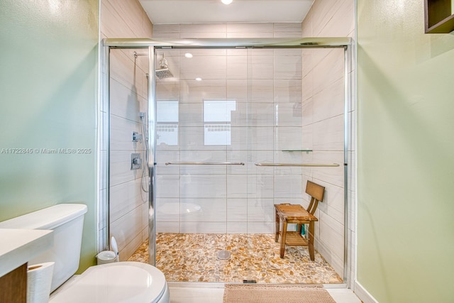 bathroom with toilet and walk in shower