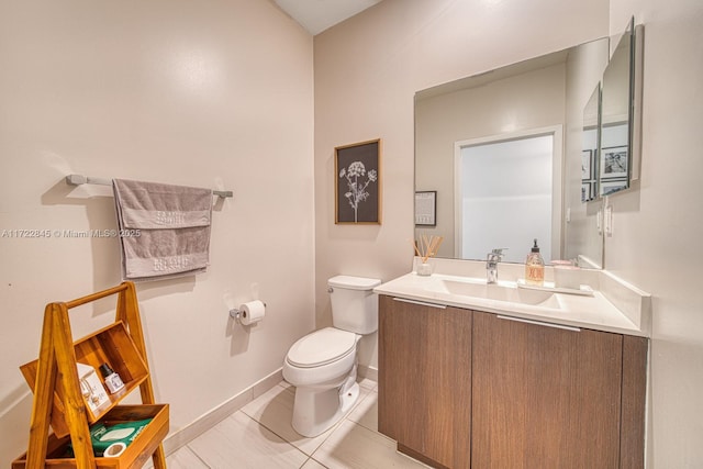 bathroom with tile patterned flooring, vanity, and toilet