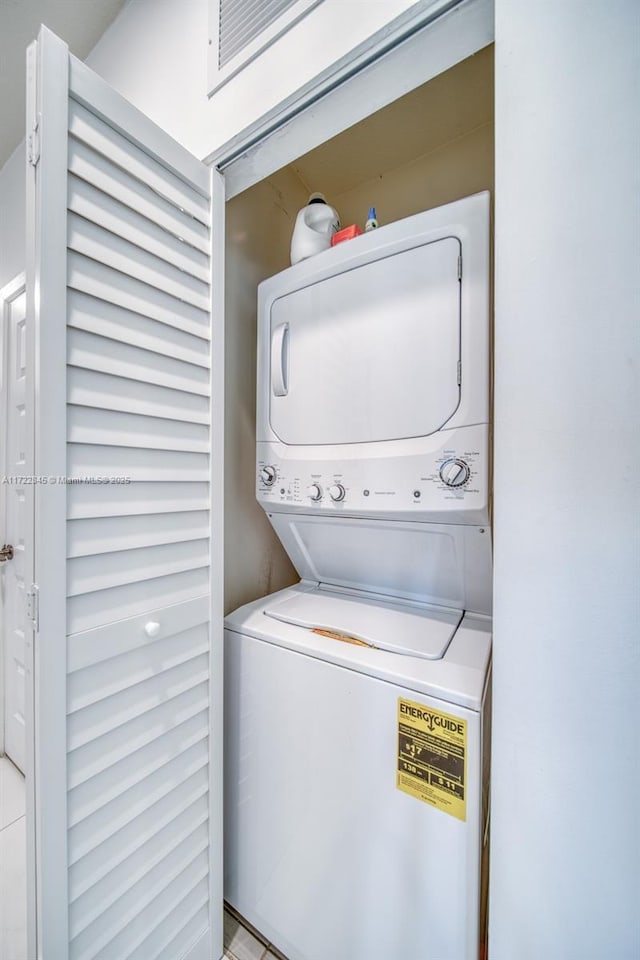 laundry room with stacked washer / dryer