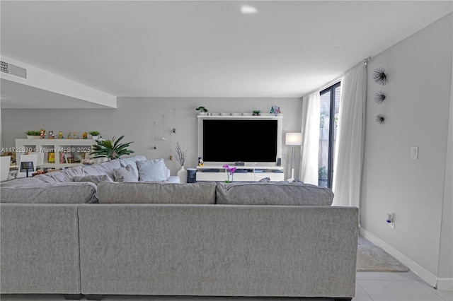 unfurnished living room featuring light tile patterned flooring