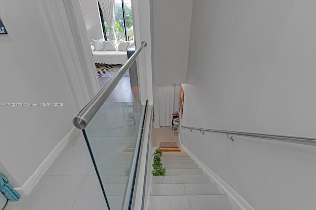 stairs featuring tile patterned floors and radiator heating unit