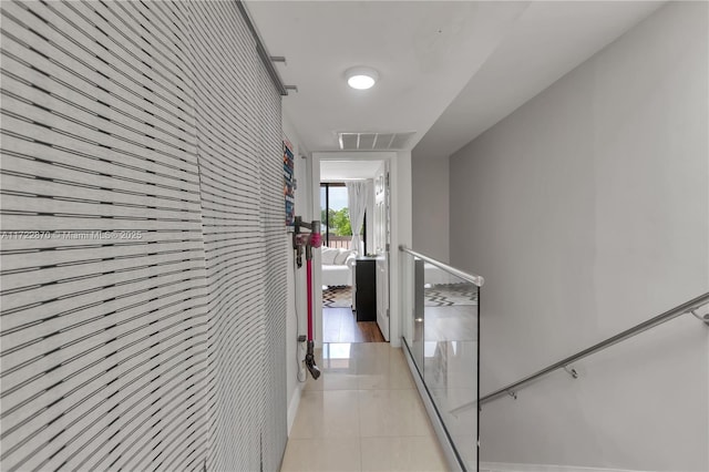 hall featuring light tile patterned flooring