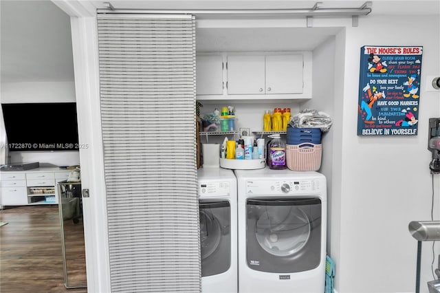 clothes washing area featuring cabinets and independent washer and dryer