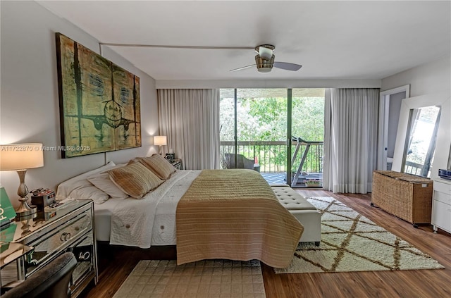 bedroom featuring access to exterior, hardwood / wood-style floors, and ceiling fan