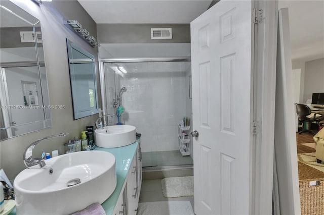 bathroom featuring vanity, tile patterned floors, and walk in shower