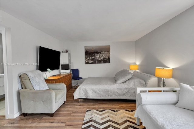 bedroom with hardwood / wood-style floors