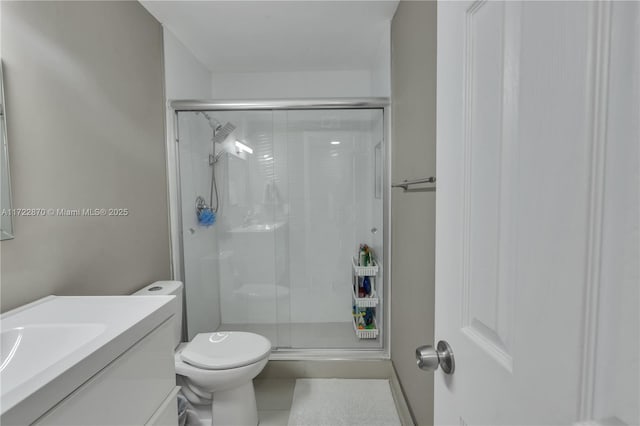 bathroom with walk in shower, tile patterned floors, vanity, and toilet