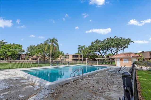 view of swimming pool with an outbuilding