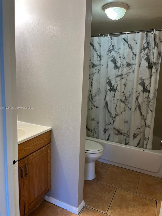 full bathroom with tile patterned flooring, vanity, toilet, and shower / tub combo with curtain