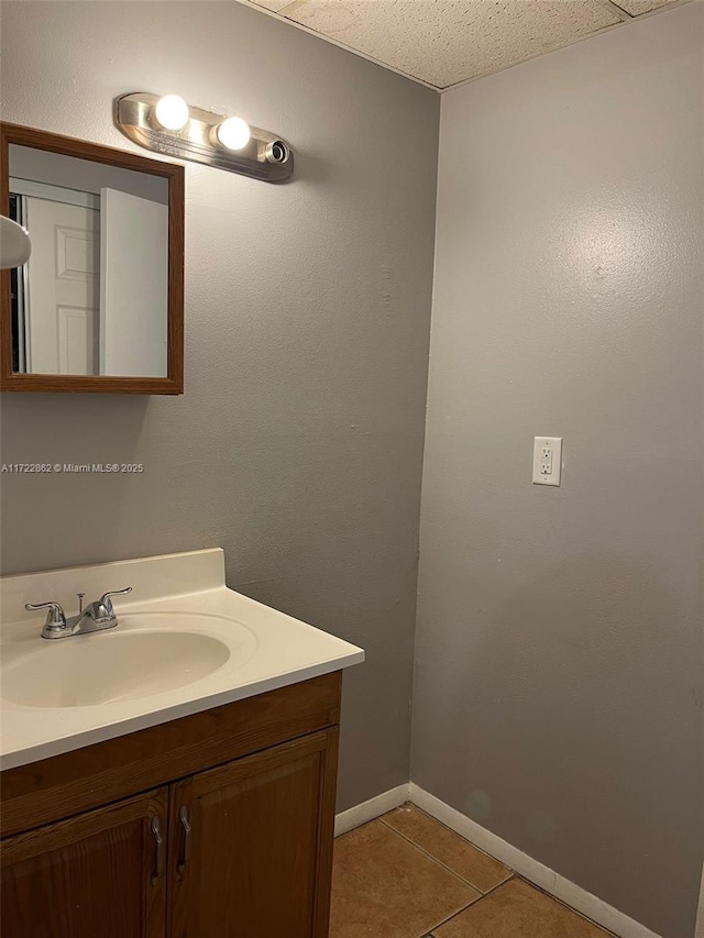 bathroom with tile patterned floors, vanity, and a textured ceiling