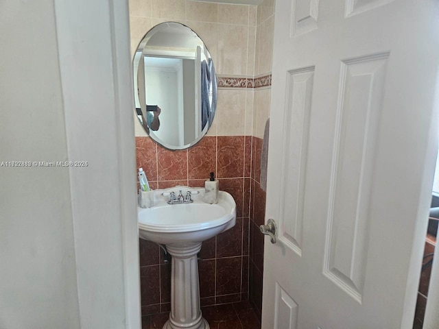 bathroom with tile walls and tasteful backsplash