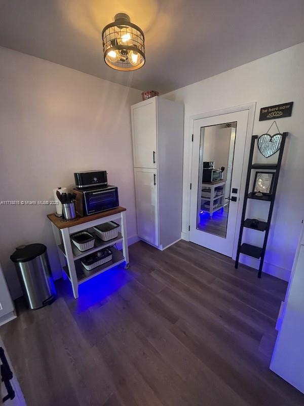 miscellaneous room featuring dark wood-type flooring