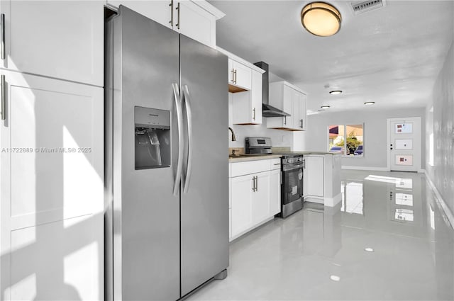 kitchen featuring white cabinets, stainless steel appliances, kitchen peninsula, and wall chimney exhaust hood