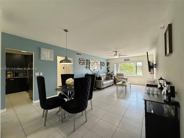dining space featuring visible vents, light tile patterned floors, and a ceiling fan