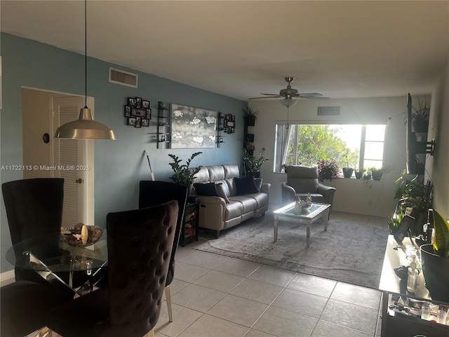 living room featuring light tile patterned floors and ceiling fan