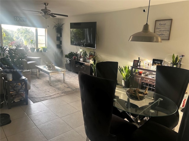 tiled dining space featuring ceiling fan