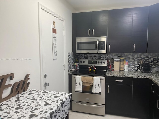 kitchen featuring stone countertops, light tile patterned floors, stainless steel appliances, and tasteful backsplash