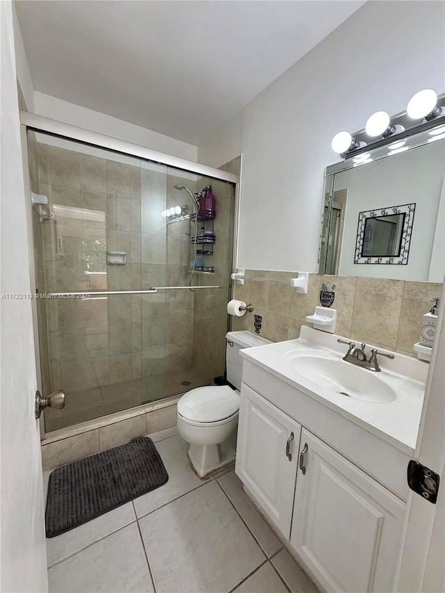 full bath with toilet, a stall shower, and tile patterned floors