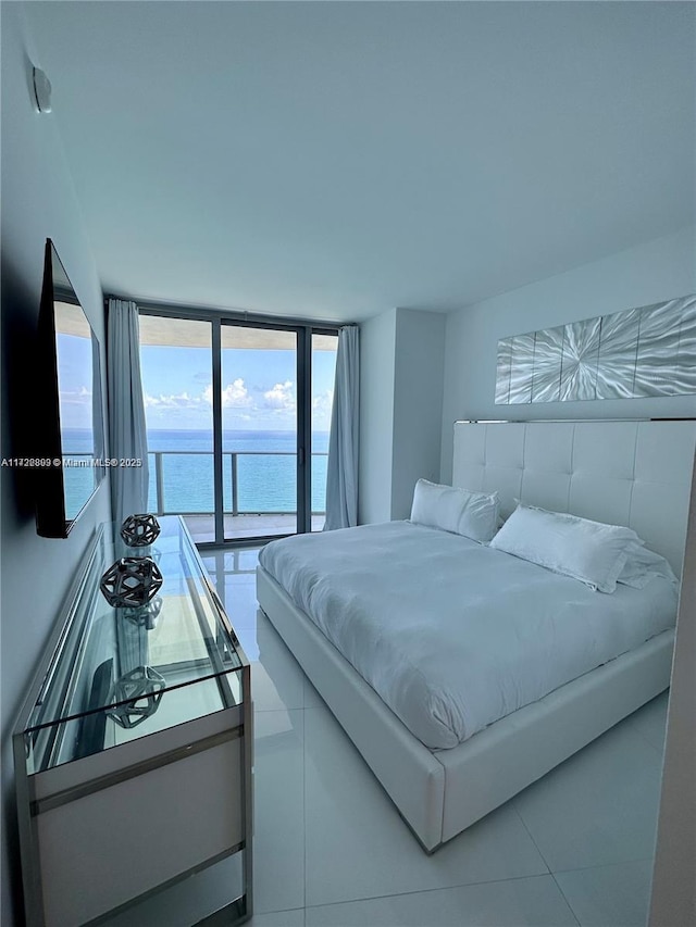 tiled bedroom featuring a water view