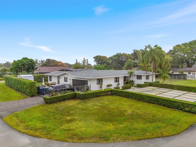 ranch-style home featuring a front yard