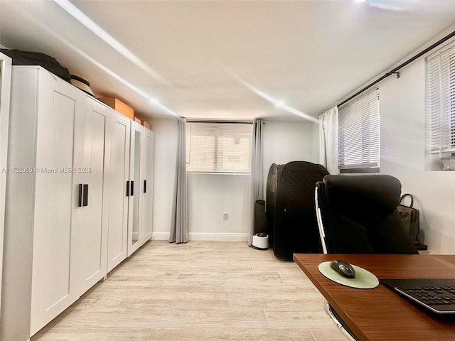 office space featuring baseboards and light wood-style floors