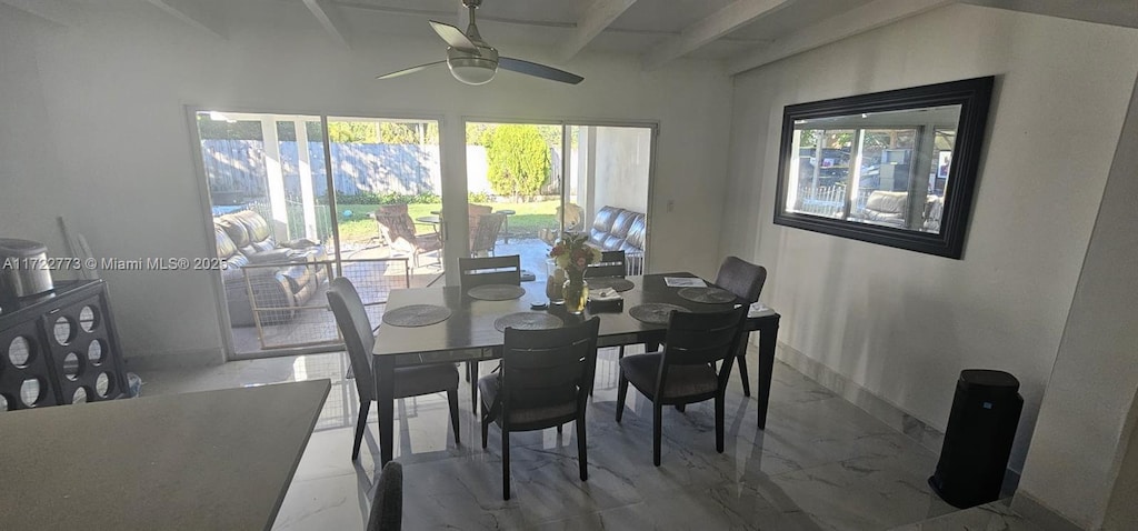 dining room with beamed ceiling and ceiling fan