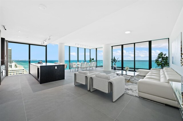 balcony featuring a water view and a beach view