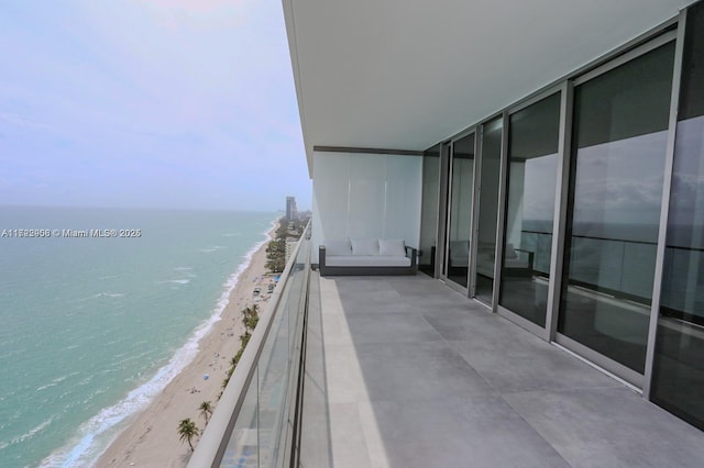 balcony with a beach view and a water view