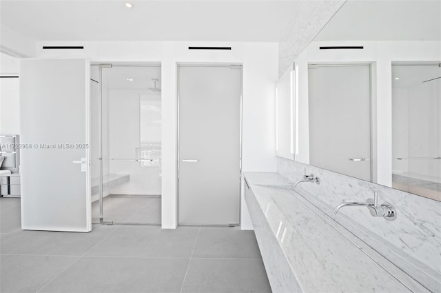 bathroom with walk in shower, tile patterned floors, and vanity