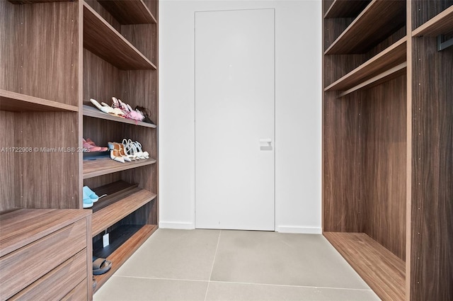 spacious closet with tile patterned floors