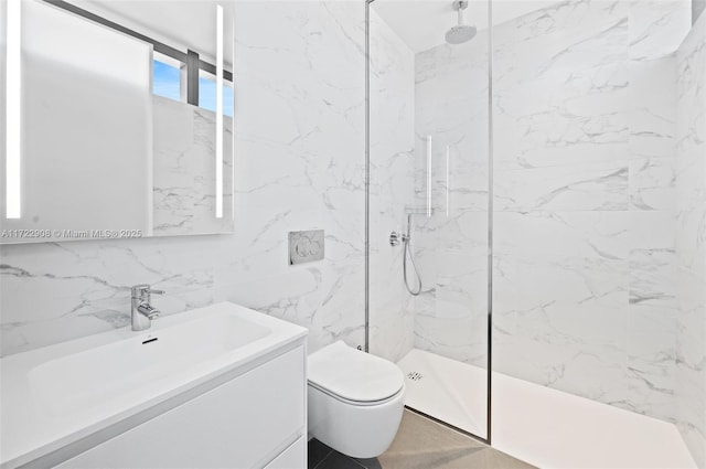 bathroom with toilet, a tile shower, tile walls, and vanity